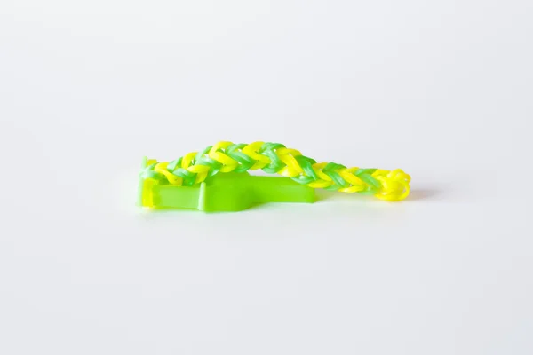 Rainbow loom- Colored rubber bands for weaving accessories on a white background