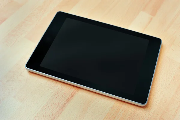Digital tablet computer with clipping path on wooden background