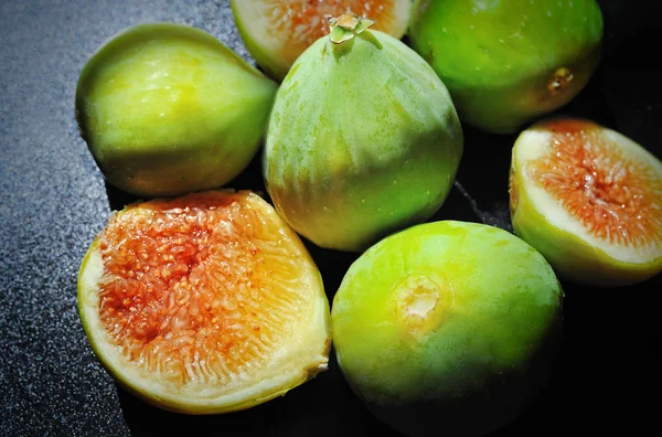 Figs sliced fruit on black background