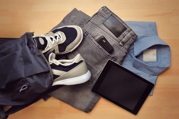 Flat view on mans clothes with gadgets