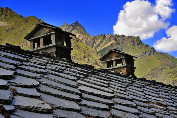 Alpien roof with chimneys in mountains