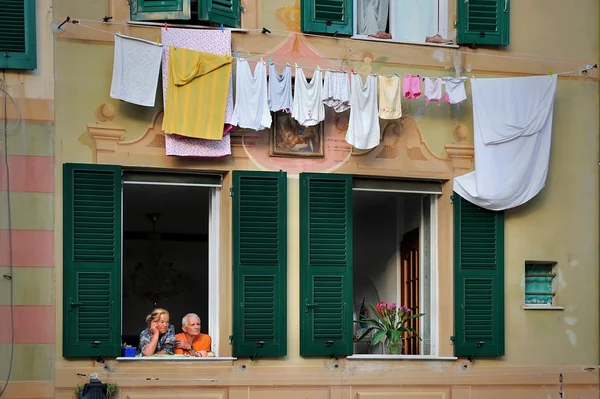 Italian older couple in love look in the window