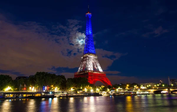 The Eiffel tower lit up with the colors of French national flag.