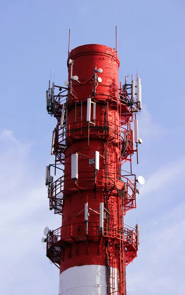 Red and white tube boiler with cables of telecommunications equipment, primarily for cellular transmission