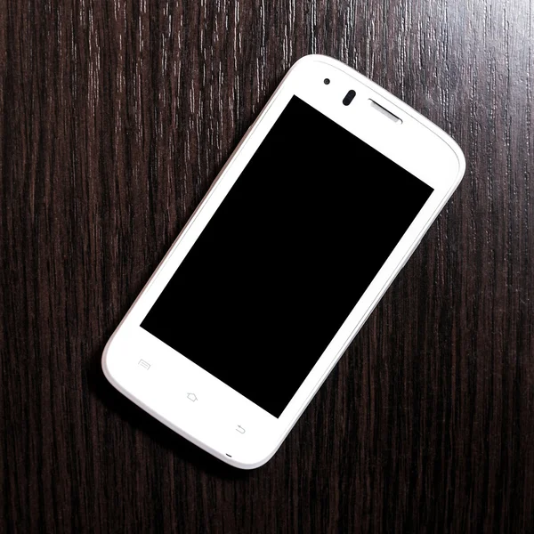 White mobile phone,smartphone on dark background