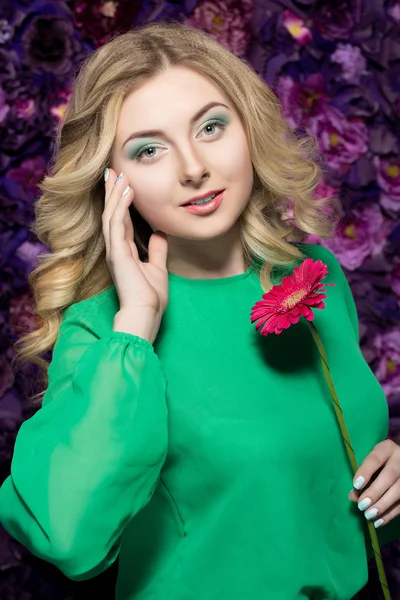 Beautiful Spa model Girl with Perfect Fresh Clean Skin. woman  holding a flower gerber . Youth and Skin Care Concept.