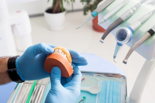 Closeup of male dental technician working in dental laboratory.dental acrylic prosthesis