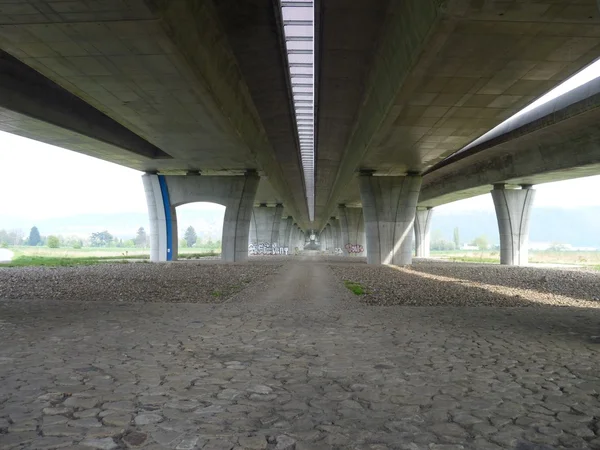 Concrete highway bridge with a pedestrian bridge below