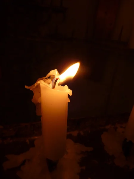 White candle light in the dark