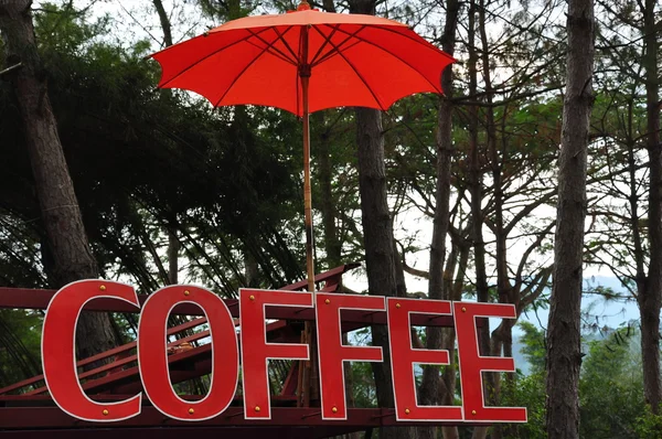 Coffee logo under umbrella