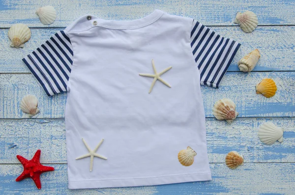 Baby  t-shirt and seastars on Shabby Chic blue and white wooden background