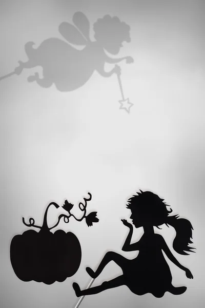 Cinderella and Pumpkin shadow puppets, Fairy Godmother shade, copy space background