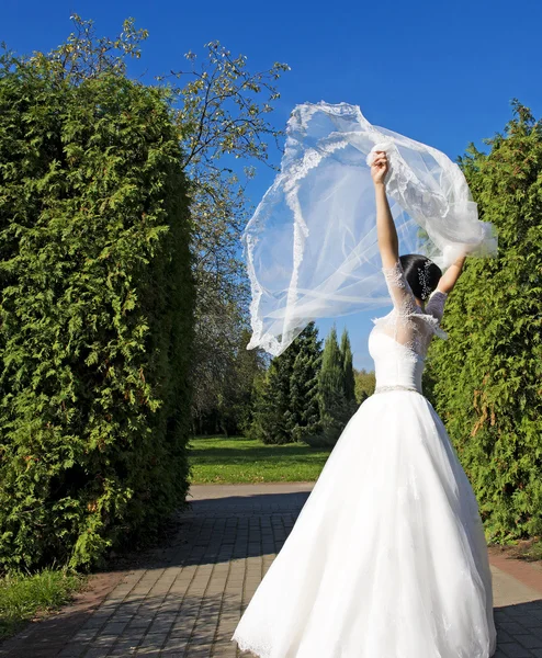 Beautiful  bride wearing white dress dancing in park.Wedding outdoor