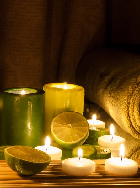 Spa and wellness setting green and yellow candles lit, lemon Green