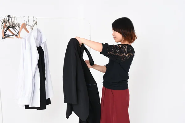 Woman hangs jacket on the hanger