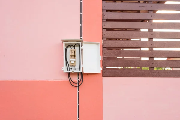 Electric switch breaker inside a cover with pink background