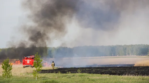 CHELYABINSK, RUSSIA - May 15, 2015: fire truck puts out in a field a forest fire