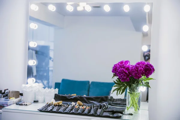 The mirror in the dressing room and makeup brush