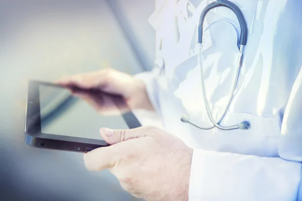 Close-up of the tablet in the hand of the doctor