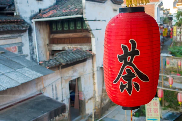 Single red chinese lantern in an old village