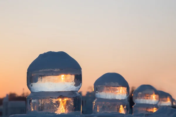Four ice balls at sunset in winter