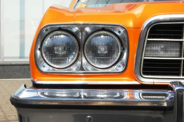 Headlights of old orange car