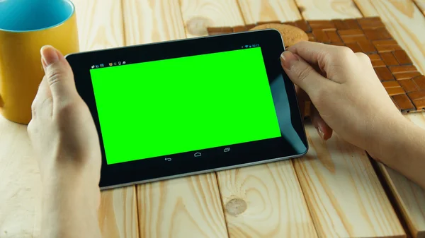 A woman uses a tablet PC at his desk. green screen replace