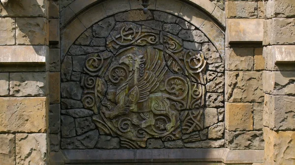 Bas-relief of coat of arms on wall of medieval castle