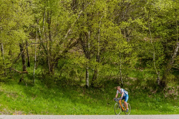 A man on a road racing bicycle
