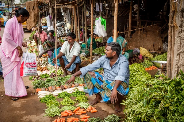 Young Indian men at their vegetable shop