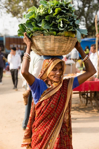 A woman carrying produce