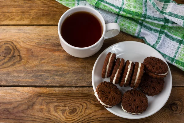Chocolate sandviches and tea cup, top view