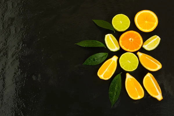 Citrus fruits on black background