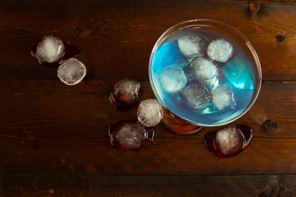 Blue Curacao liqueur with ice, top view