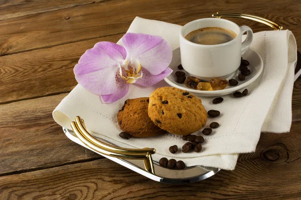 Coffee served with orchid on the serving tray