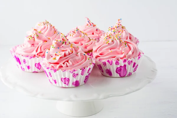 Decorated pink birthday cupcakes  on the cake stand