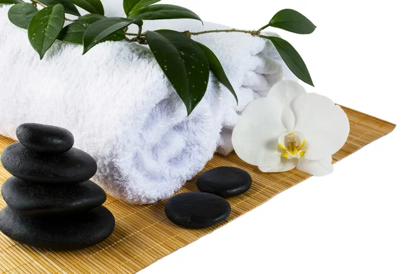 Spa concept with white orchid and spa stones isolated on white