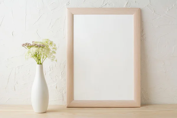 Frame mockup with tender flowers in white stylish vase
