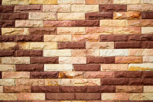 Dark brown stone brick wall background