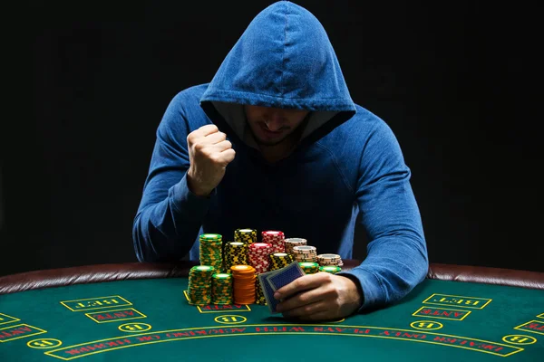 Portrait of a professional poker player sitting at pokers table