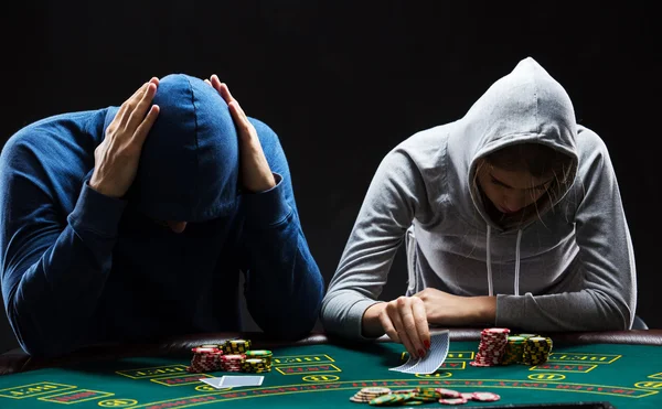 Two professional poker players sitting at a table