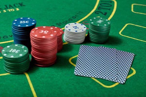 Casino chips and cards on casino table, poker game concept