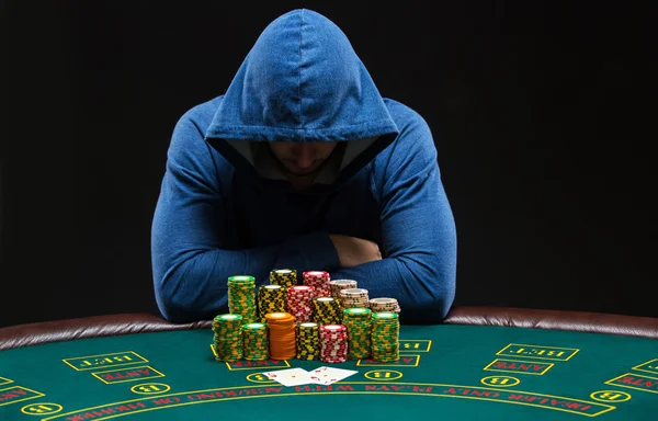 Portrait of a professional poker player sitting at pokers table