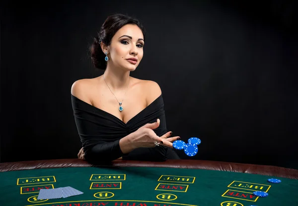 Sexy woman with poker cards and chips