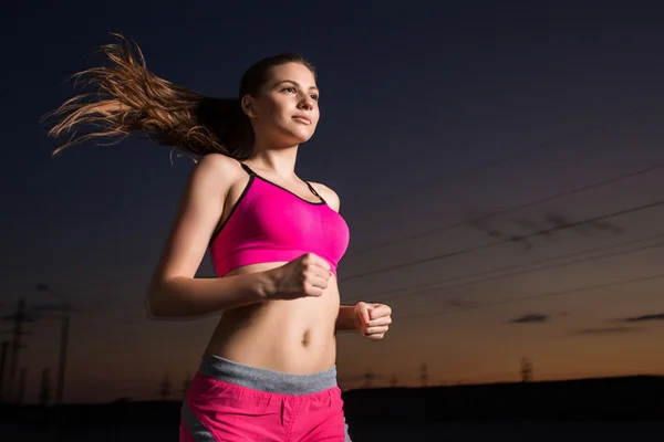 Running woman. Runner jogging in evening.