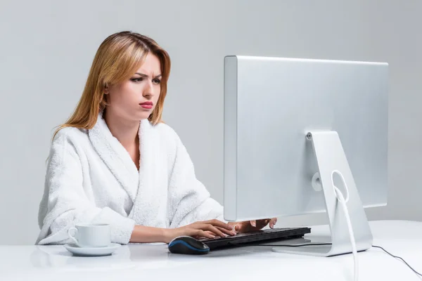 Young woman sitting in the table and using computer