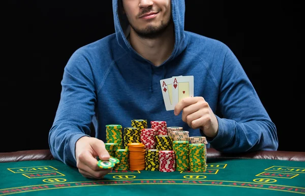 Poker player showing a pair of aces. Closeup