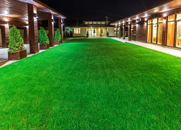 Detached house at night  view from outside the rear courtyard.