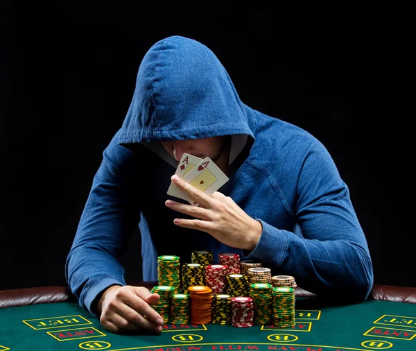 Poker player showing a pair of aces