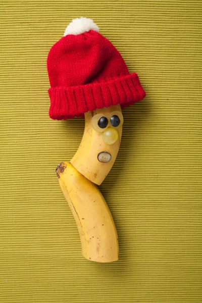 Happy banana in red hat